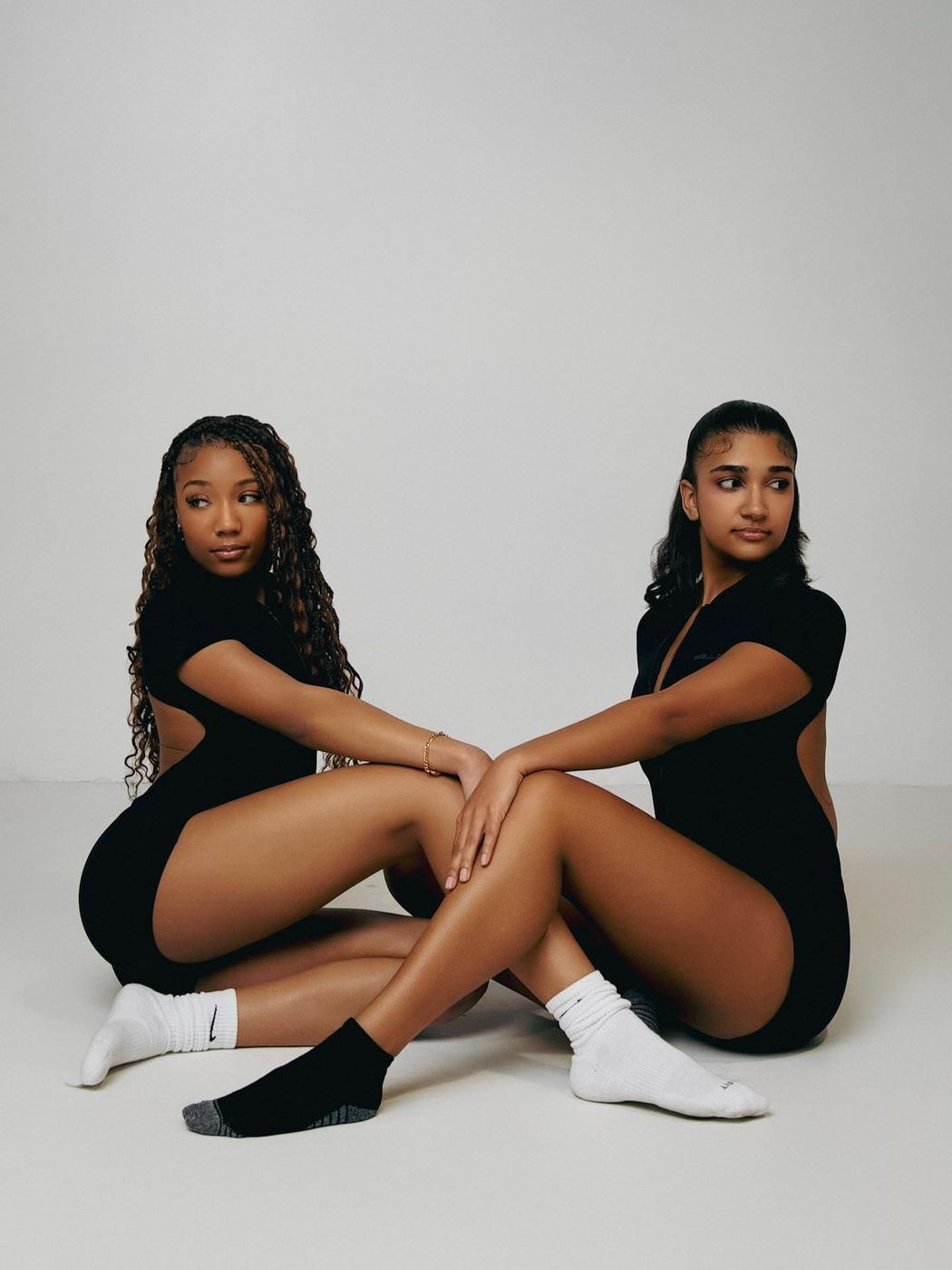 Two women in black Bellz bodysuits, studio