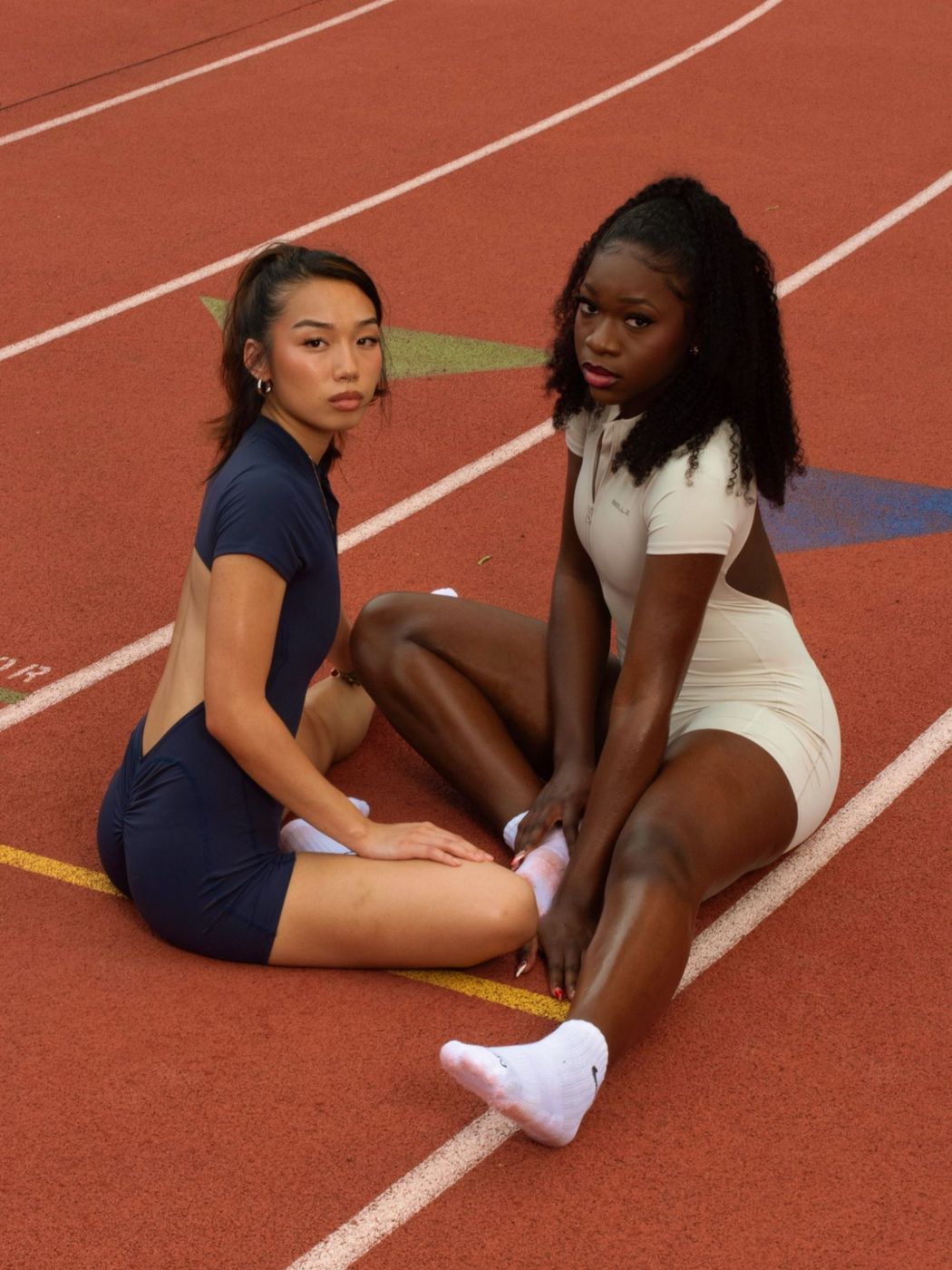 Navy and cream Bellz bodysuits on the track